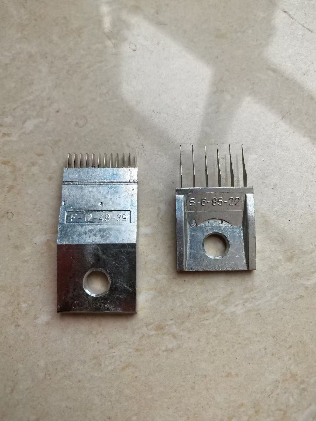 Warp knitting needle blocks with stamped reference codes